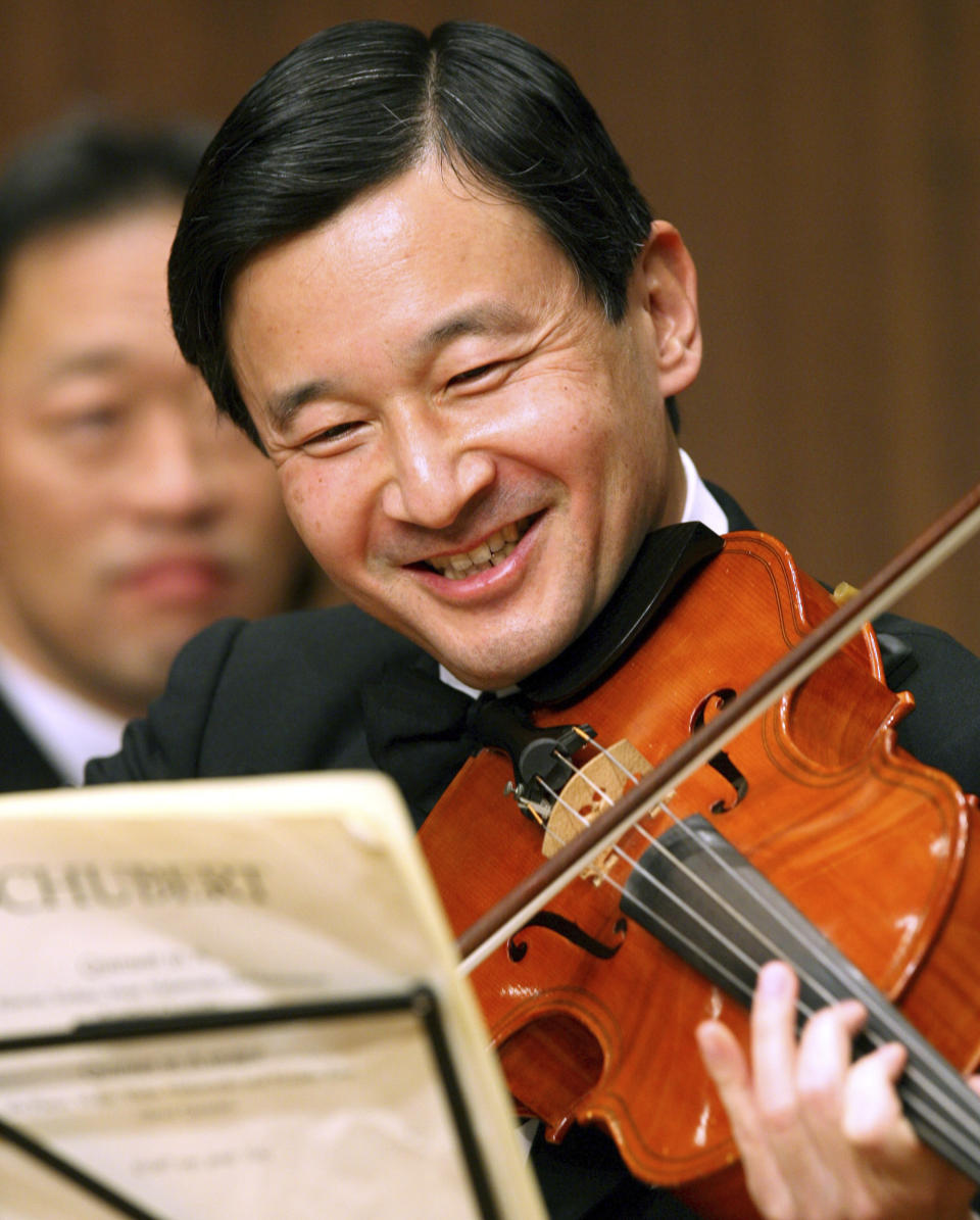 FILE - In this Jan. 22, 2007, file photo, Japan's Crown Prince Naruhito plays the viola during a photo session prior to a friendship concert in Tokyo. Japan’s new emperor is a team player, musician and historian who will bring a global perspective to an ancient institution. (AP Photo/Koji Sasahara, File)