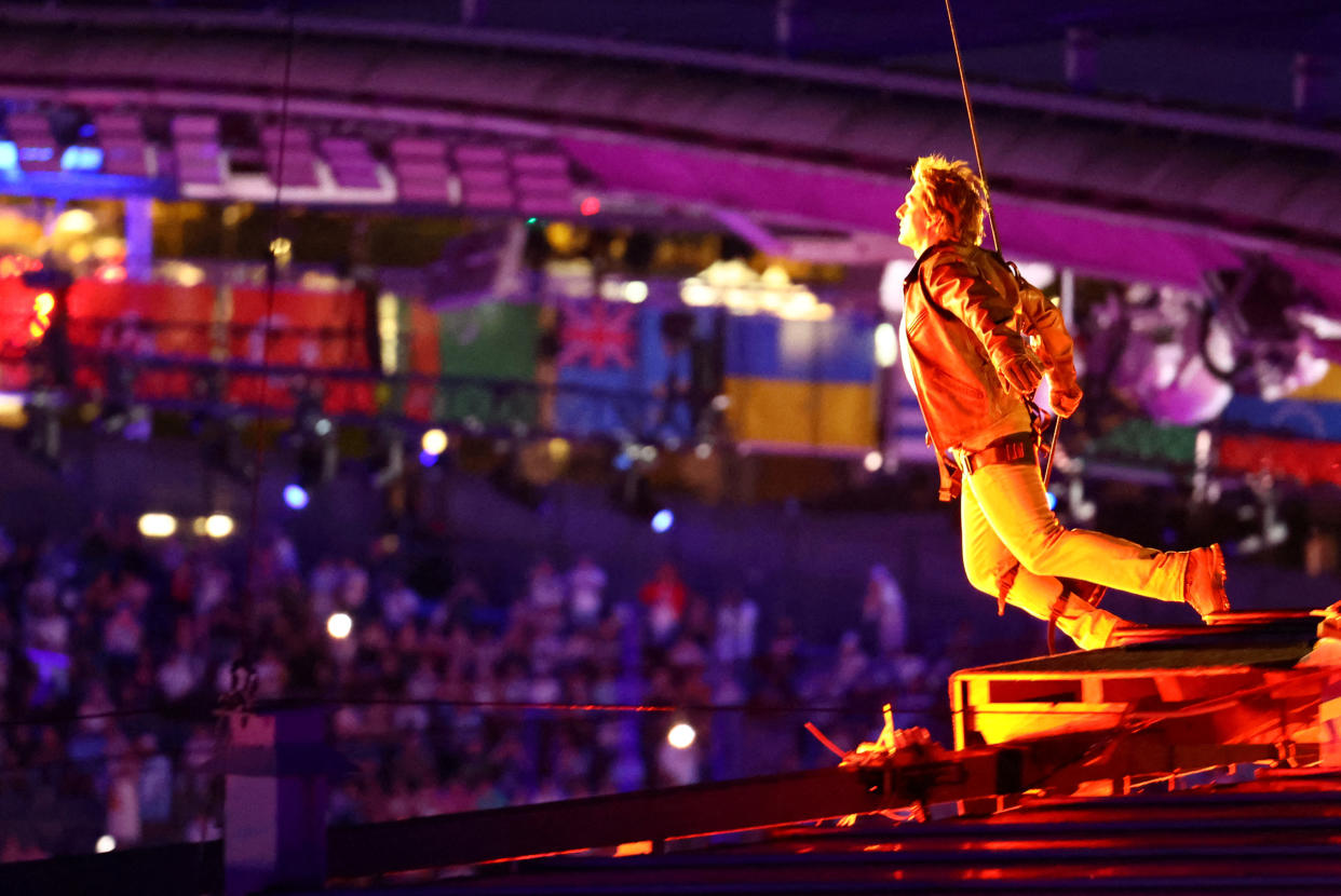 Actor Tom Cruise jumps from the roof of the Stade de France during the closing ceremony of the Olympic Games.