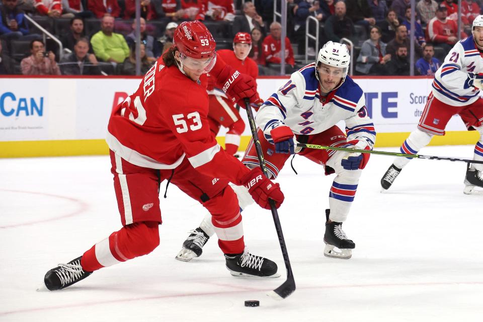 Red Wings defenseman Moritz Seider attempts to control the puck alongside Rangers' Sammy Blais during the first half on Thursday, November 10, 2022 at Little Caesars Arena.