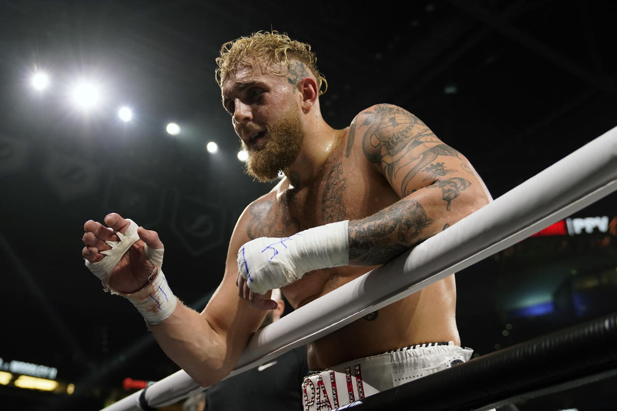Jake Paul reacts after knocking out Tyron Woodley during the sixth round of a Cruiserweight fight Sunday, Dec. 19, 2021, in Tampa, Fla. (AP Photo/Chris O'Meara)