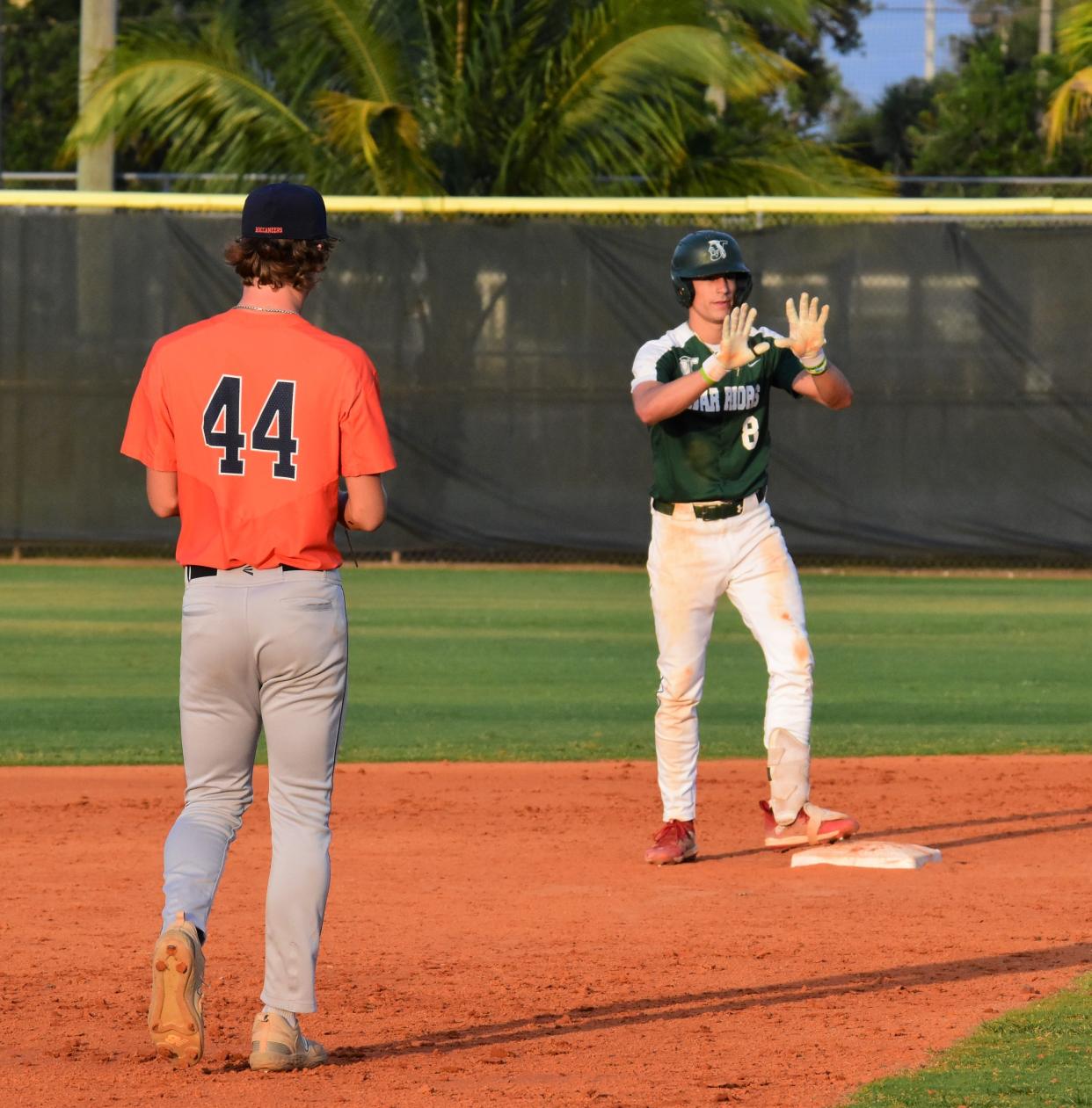 Jupiter's Gabe Graulau signals in celebration to the dugout after his bases-loaded double against Benjamin on April 22, 2024.