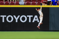 Cincinnati Reds' Nick Senzel leaps at the wall to make the catch on a ball hit by Chicago Cubs' Willson Contreras during the ninth inning of a baseball game in Cincinnati, Wednesday, May 25, 2022. The Reds won 4-3. (AP Photo/Aaron Doster)