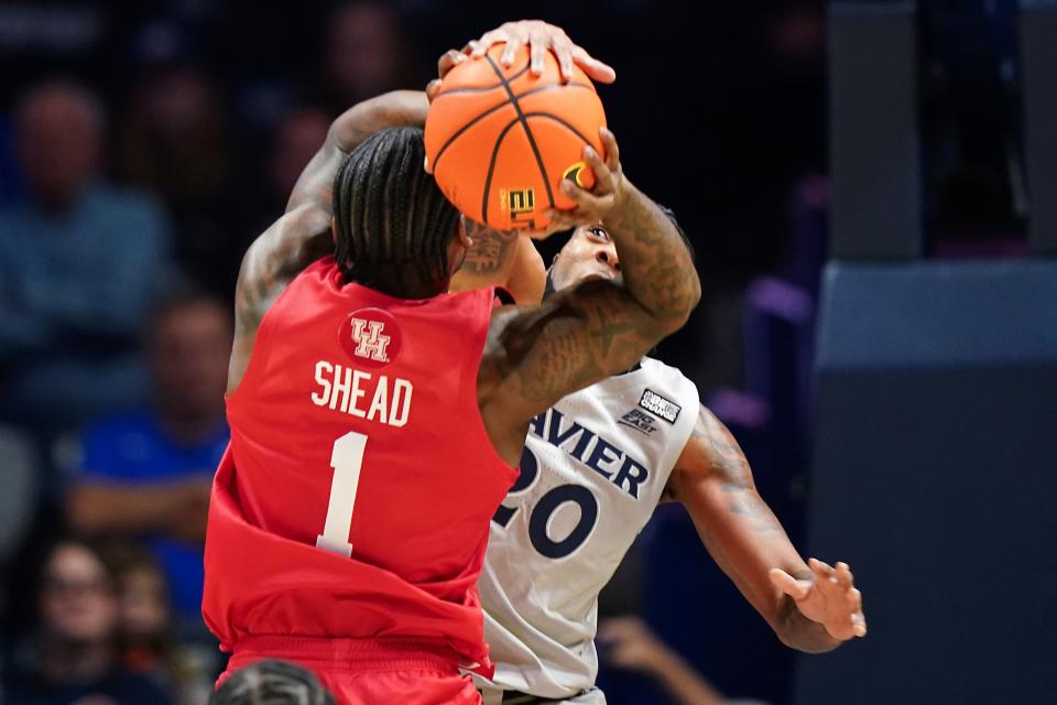 Xavier Musketeers guard Dayvion McKnight (20) defends on Houston Cougars guard Jamal Shead (1) in the first half of an NCAA college basketball game between the Houston Cougars and the Xavier Musketeers, Friday, Dec. 1, 2023, at Cintas Center in Cincinnati.