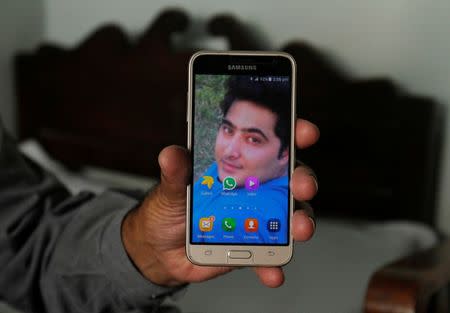 Iqbal Khan shows a picture of his son Mashal set as the wallpaper on his phone at the family home in Swabi, Pakistan October 24, 2017. Picture taken October 25, 2017. REUTERS/Fayaz Aziz NO RESALES. NO ARCHIVES