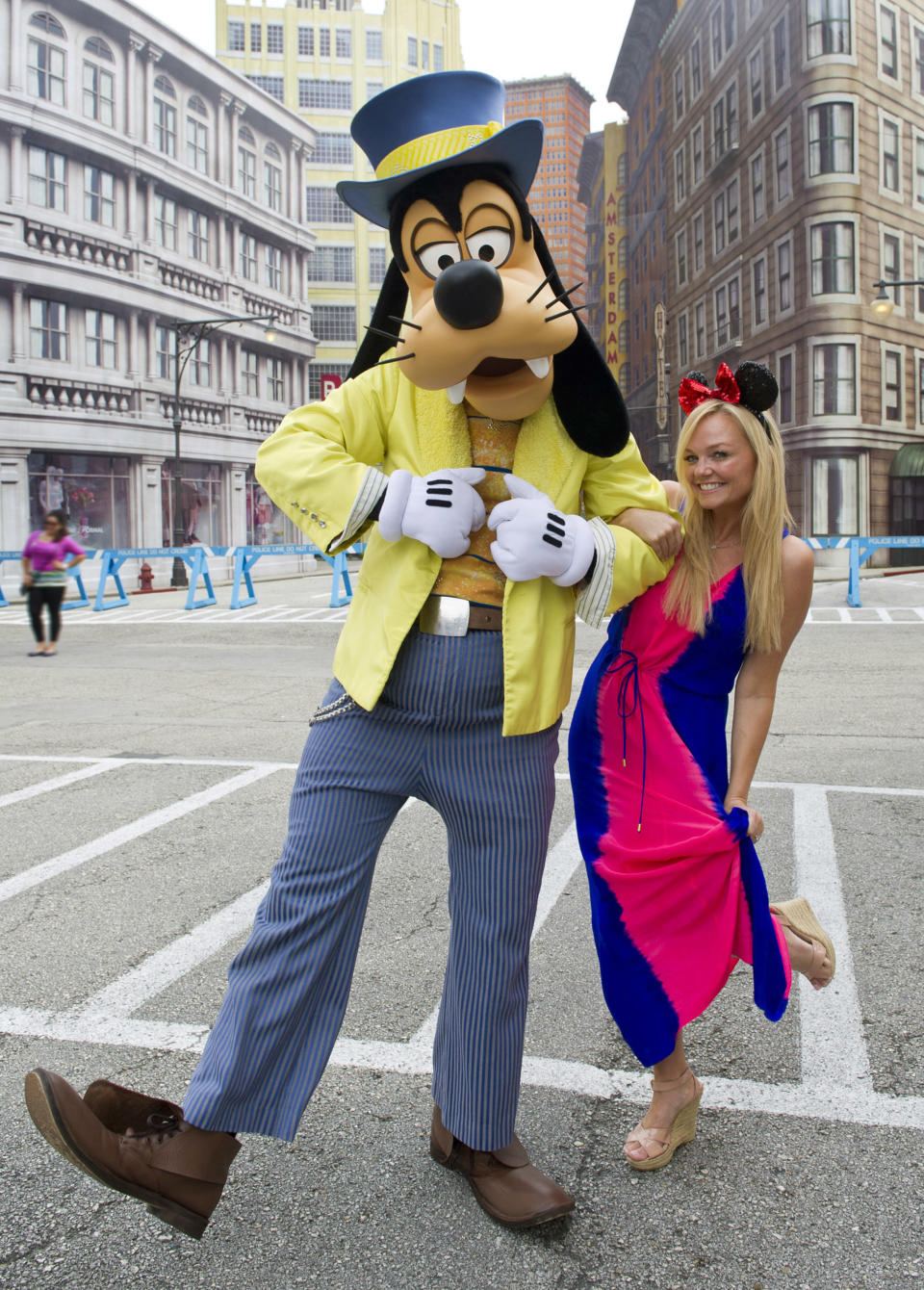 Singer and U.K. radio presenter Emma Bunton, known as 'Baby Spice' as a member of the all-girl pop group The Spice Girls, poses with Goofy at Disney's Hollywood Studios theme park September 25, 2012 in Lake Buena Vista, Florida.   (Photo by Gene Duncan/Disney Parks via Getty Images)