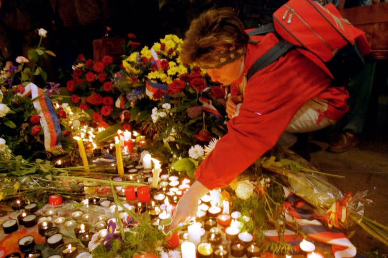 A woman lights a candle November 17, 1999, in Prague at the monument commemorating a violent attack by police in 1989 on students during the beginnings of Czechoslovakia's Velvet Revolution. The revolution led to the dissolution of Czechoslovakia into the Czech Republic and Slovakia, which happened on this day in 1993. File Photo by Sean Gallup/UPI