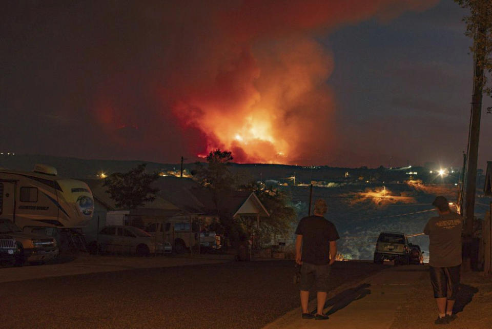 In this photo provided by Joseph Pacheco, a wildfire is seen burning in Globe, Ariz., on Monday, June 7, 2021. Firefighters in Arizona were fighting Tuesday to gain a foothold into a massive wildfire, one of two that has forced thousands of evacuations in rural towns and closed almost every major highway out of the area. (Joseph Pacheco via AP)