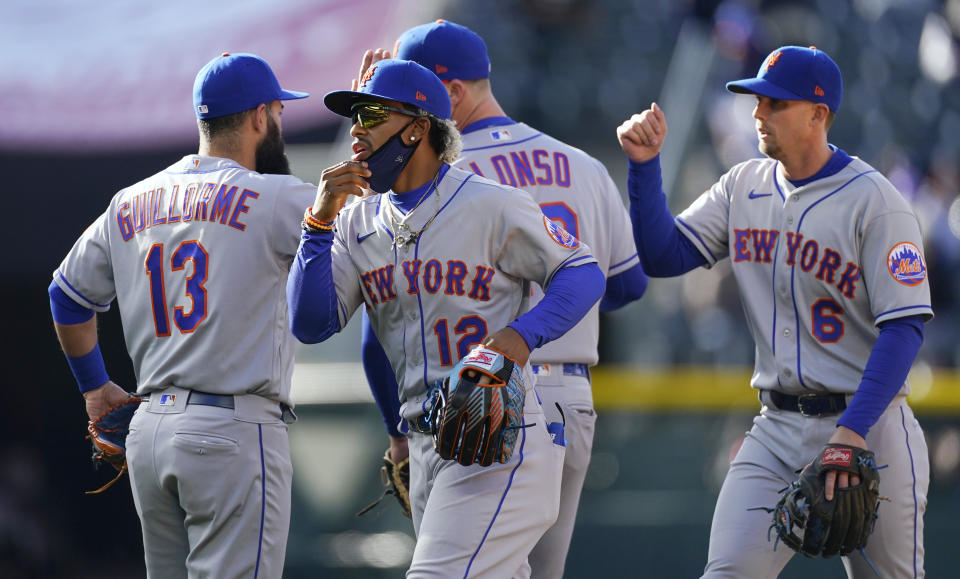 New York Mets shortstop Francisco Lindor (12) celebrates with teammates after the first game of a baseball doubleheader against the Colorado Rockies on Saturday, April 17, 2021, in Denver. The Mets won 4-3. (AP Photo/David Zalubowski)