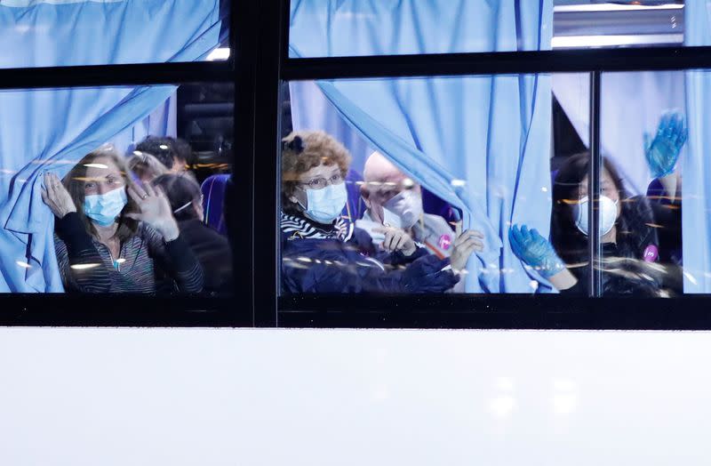 Buses believed to carry the U.S. passengers of the cruise ship Diamond Princess, where dozens of passengers were tested positive for coronavirus, leave at Daikoku Pier Cruise Terminal in Yokohama, south of Tokyo