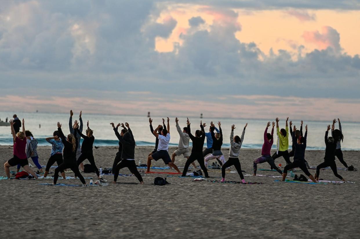 For some, yoga is a spiritual practice that may substitute for religion. <a href="https://www.gettyimages.com/detail/news-photo/group-of-people-participate-in-a-yoga-session-taught-by-news-photo/1231905854?adppopup=true" rel="nofollow noopener" target="_blank" data-ylk="slk:CHANDAN KHANNA/AFP via Getty Images;elm:context_link;itc:0;sec:content-canvas" class="link ">CHANDAN KHANNA/AFP via Getty Images</a>