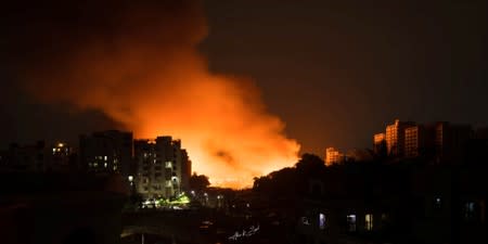 Flames engulf a slum after a fire broke out in Dhaka