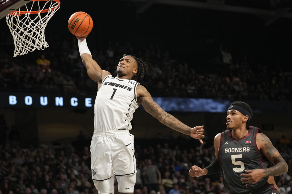 Central Florida guard Antwann Jones (1) gets past Oklahoma guard Rivaldo Soares (5) for a dunk during the second half of an NCAA college basketball game, Saturday, Feb. 3, 2024, in Orlando, Fla. (AP Photo/John Raoux)