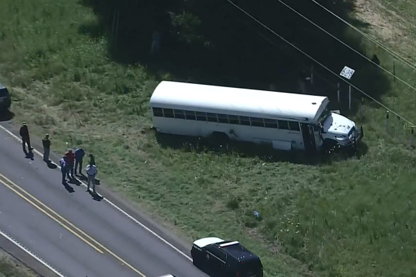 Authorities investigate the area around a prisoner transport bus after an inmate serving a life sentence for murder escaped Thursday in Texas after he stabbed the driver, authorities say. (KPRC)