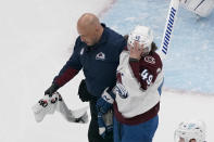 Colorado Avalanche's Samuel Girard (49) is helped off the ice by a trainer after being injured during the first period in Game 3 of an NHL hockey Stanley Cup second-round playoff series against the St. Louis Blues Saturday, May 21, 2022, in St. Louis. (AP Photo/Jeff Roberson)