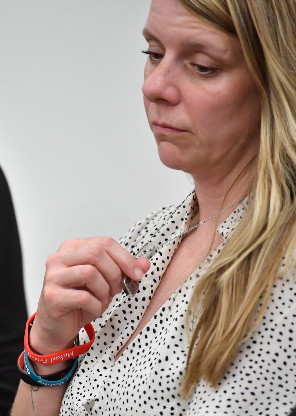 Gabby Petito's mother, Nichole Schmidt, holds a heart-shaped locket containing Gabby's ashes as listen to arguments by an attorney for Brian Laundrie's parents as he seeks to have a negligence lawsuit dismissed in court in Sarasota County, Florida on Wednesday, June 22, 2022.  Petito and Schmidt claim in their lawsuit that the Laundrie's acted maliciously by not telling them where their daughter was and if she was alive..