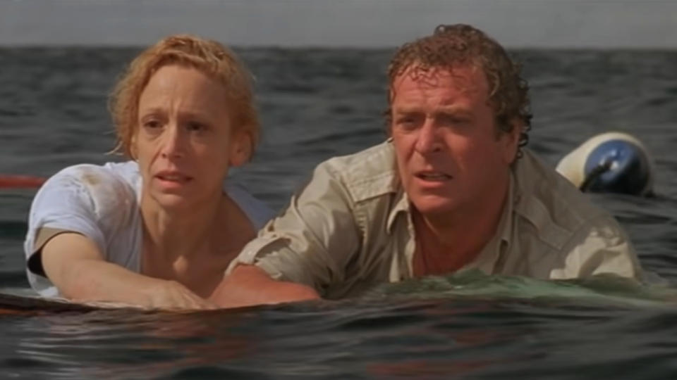 Lorraine Gary and Michael Caine floating together on some wreckage in Jaws: The Revenge.