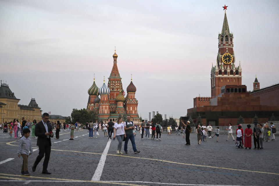 People stroll at the Red Square in Moscow, Russia, Tuesday, Aug. 1, 2023. The glittering towers of the Moscow City business district were once symbols of the Russian capital's economic boom in the early 2000s. Now they are a sign of its vulnerability, following a series of drone attacks that rattled some Muscovites shaken and brought the war in Ukraine home to the seat of Russian power. (AP Photo/Dmitry Serebryakov)
