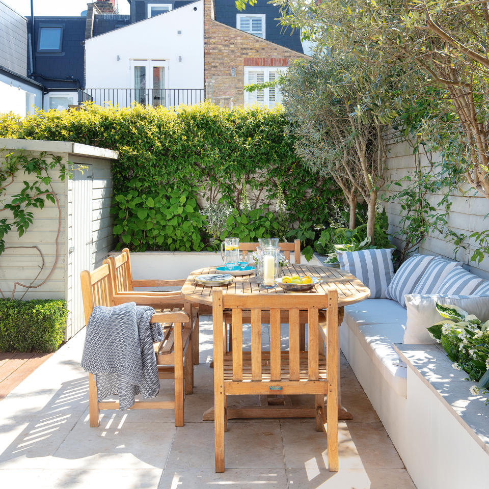 Outdoor dining area with wooden furniture and built in bench