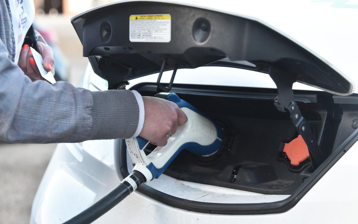 A lady is seen using a electric vehicle charging pod point on November 15, 2020 in Stoke-On-Trent - Nathan Stirk/Getty 