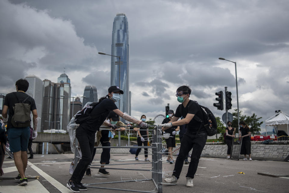 Protesters are seen moving barricades down the road in Hong Kong, China. 1 July 2019. Protesters today clash with police with police using pepper spray and  batons to disperses Protesters , protesters started occupying road early morning on the 22th anniversary of the handover of Hong Kong From the United Kingdom to China. (Photo by Vernon Yuen/NurPhoto via Getty Images)