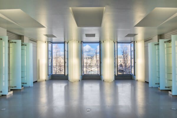 Large French doors open up to capture panoramic views of the Seine.