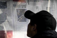 A man reads a newspaper headline reporting on China's protest against the U.S. shooting down a Chinese balloon at a newstand in Beijing, Monday, Feb. 6, 2023. China on Monday accused the United States of indiscriminate use of force when the American military shot down a suspected Chinese spy balloon Saturday, saying that had "seriously impacted and damaged both sides' efforts and progress in stabilizing Sino-U.S. relations." (AP Photo/Andy Wong)
