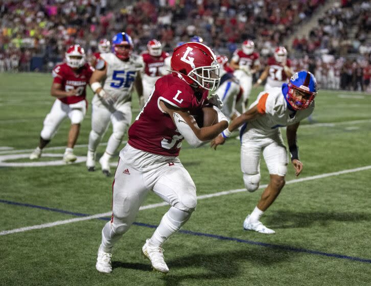 Costa Mesa, CA - August 19: Orange Lutheran running back Antonio Barrera outruns Gardena Serra.