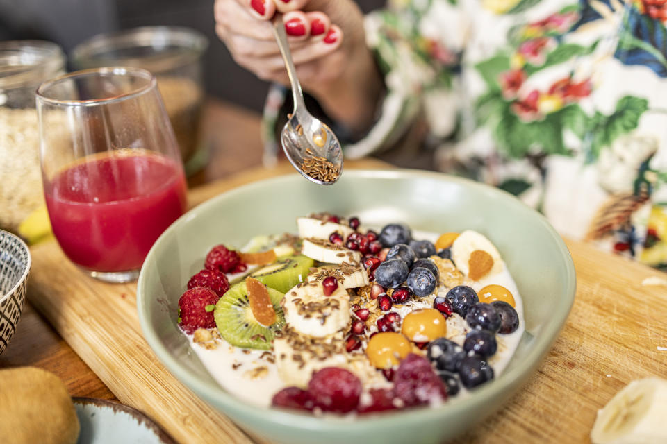 Adding flaxseeds to a breakfast bowl. (Getty Images)