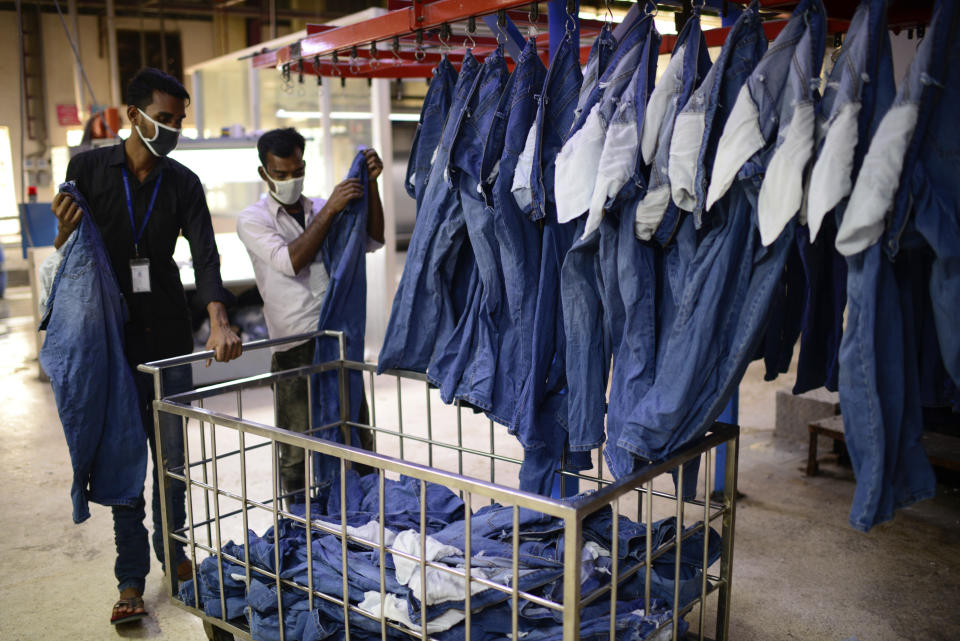 Garment factory employees work at Arrival Fashion Ltd. in Gazipur, Bangladesh, Saturday, March 13, 2021. On the eve of a half-century of independence this week, Bangladesh has been hailed as a success story for a young nation born out of strife and turbulence. Millions have risen out of poverty as the country has unexpectedly become one of Asia’s fastest-growing economies thanks to sectors like its garment industry, which clothes millions around the world. (AP Photo/Mahmud Hossain Opu)