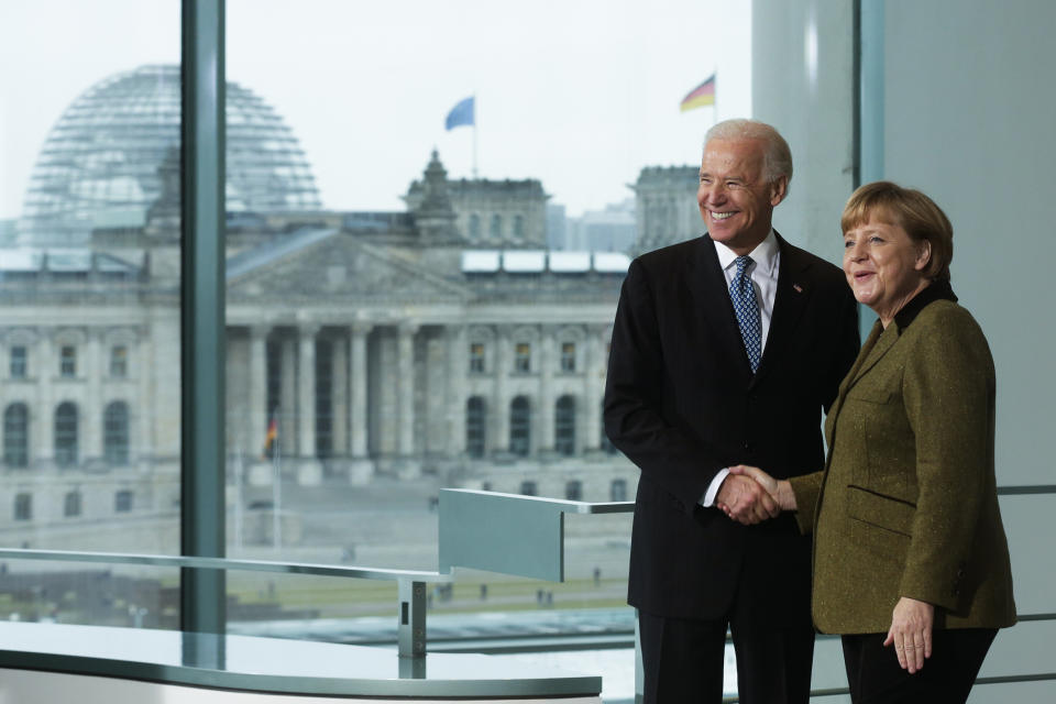 File---File picture taken Friday, Feb. 1, 2013. German Chancellor Angela Merkel, right, and United States' Vice President Joe Biden briefing the media prior to a meeting at the chancellery in Berlin, Germany. Building in the background is the Reichstag, that hosts the German parliament. (AP Photo/Markus Schreiber,file)