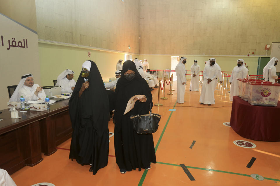 Qataris arrive to vote in legislative elections in Doha, Qatar, Saturday, Oct. 2, 2021. For the first time citizens will elect two-thirds of Shura council while emir will appoint the remaining 15 members. (AP Photo/Hussein Sayed)