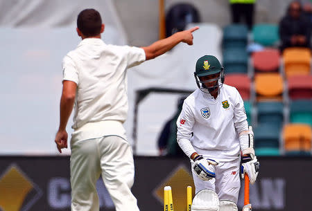 Cricket - Australia v South Africa - Second Test cricket match - Bellerive Oval, Hobart, Australia - 14/11/16. South Africa's Keshav Maharaj reacts as Australia's Josh Hazlewood points after bowling him. REUTERS/David Gray