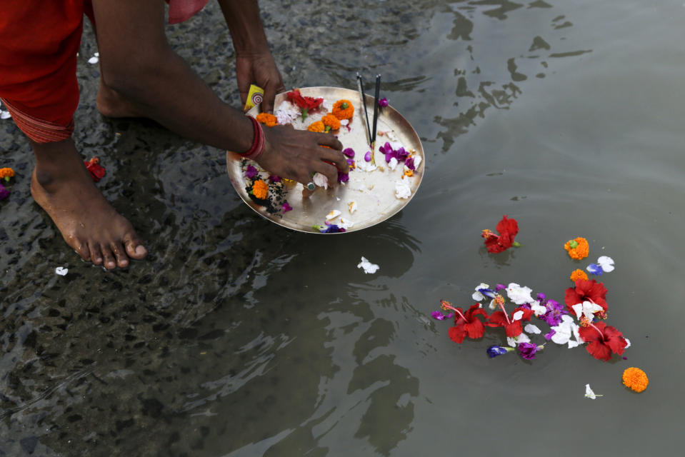 <p>A Hindu priest performs rituals during Durga Puja festival on the banks of the Ganges River in Kolkata, India, Wednesday, Sept. 27, 2017. The five-day festival commemorates the slaying of a demon king by goddess Durga, marking the triumph of good over evil. (Photo: Bikas Das/AP) </p>