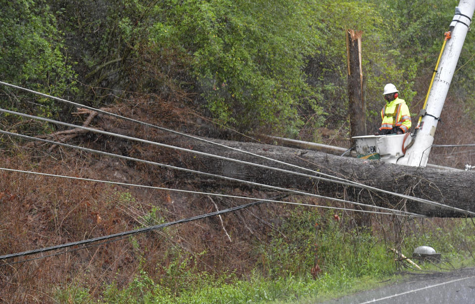 Crew members clean up fallen trees in Roswell, Ga., on Wednesday, April 5, 2017. Severe weather toppled trees and power lines as dangerous storms battered the Deep South with heavy rain and hail as large as baseballs in spots. (Hyosub Shin/Atlanta Journal-Constitution via AP)