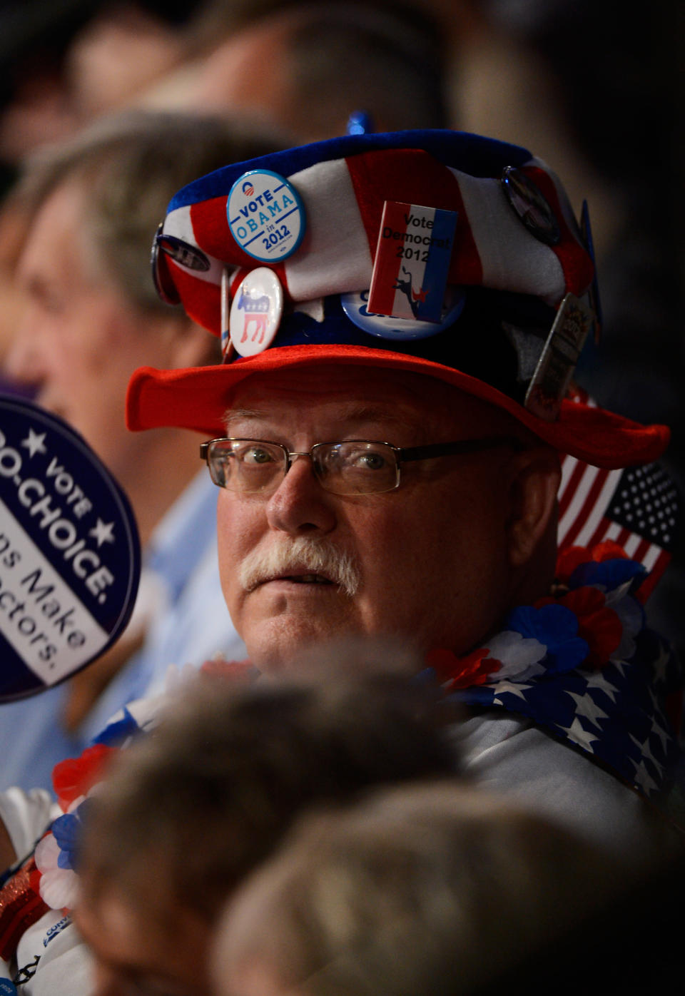 A man wears a hat decorated with campaign pins during the final day of the Democratic National Convention at Time Warner Cable Arena on September 6, 2012 in Charlotte, North Carolina. (Photo by Kevork Djansezian/Getty Images)