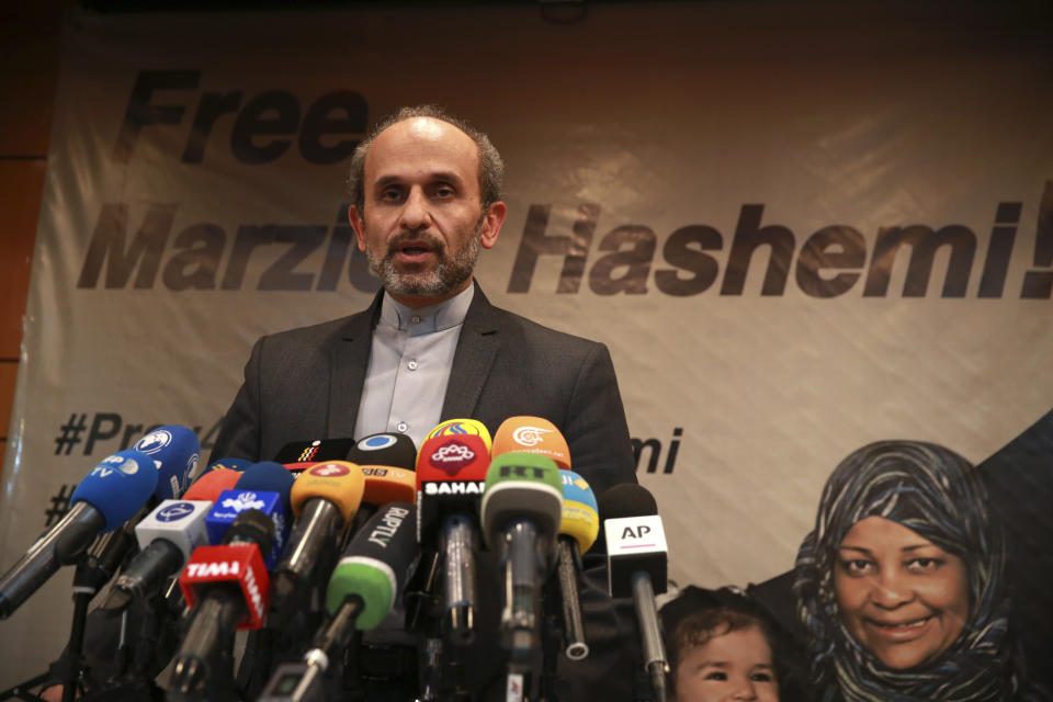 Paiman Jebeli, deputy chief of Iran's state IRIB broadcaster gives a press briefing about American-born news anchor on Iranian state television's English-language service, Marzieh Hashemi, shown in banner, in Tehran, Iran, Wednesday, Jan. 16, 2019. Hashemi has been arrested after flying into the U.S., the broadcaster reported Wednesday. The reported detention of Press TV's Hashemi, born Melanie Franklin of New Orleans, comes as Iran faces increasing criticism of its own arrests of dual nationals and others with Western ties, previously used as bargaining chips in negotiations with world powers. (AP Photo/Vahid Salemi)