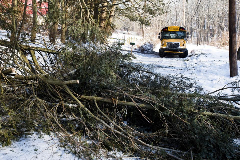 A school bus is block by down trees in the aftermath of a winter storm, Friday, Feb. 7, 2014, in Downingtown, Pa. Schools canceling classes because of winter weather in at least 10 states have used up the wiggle room in their academic calendars, forcing them to schedule makeup days or otherwise compensate for the lost time. (AP Photo/Matt Rourke)