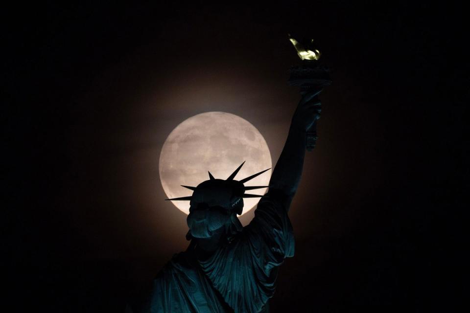 The Super Blue Moon rises behind the Statue of Liberty seen from Liberty State Park in Jersey City, NJ on Aug. 30, 2023.<span class="copyright">Tariq Zehawi—NorthJersey.com/USA TODAY NETWORK/Reuters</span>