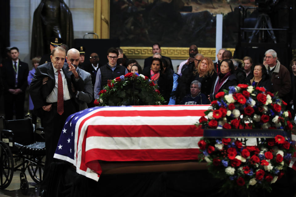Former Sen. Bob Dole salutes the flag-draped casket containing the remains of former President George H.W. Bush as he lies in state at the U.S. Capitol in Washington, Tuesday, Dec. 4, 2018. (AP Photo/Manuel Balce Ceneta)
