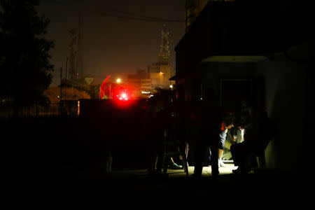 People stand outside a house during a blackout in Puerto Ordaz, Venezuela, March 9, 2019. REUTERS/William Urdaneta