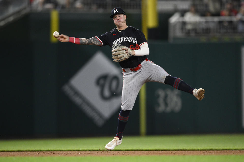 Minnesota Twins third baseman Jose Miranda throws to first to put out Washington Nationals' Joey Meneses during the eighth inning of a baseball game, Monday, May 20, 2024, in Washington. (AP Photo/Nick Wass)