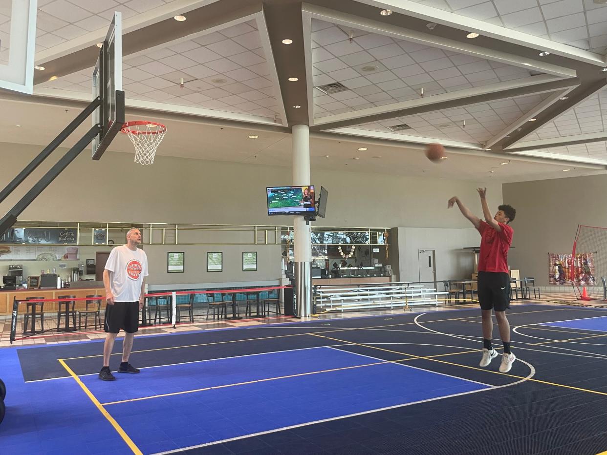 Kevin Nicefield, left, trains Xzavier Callahan, right, at the basketball court inside Birchwood Mall on July 25, 2023. The basketball court was the first of many indoor sport courts coming to the mall.