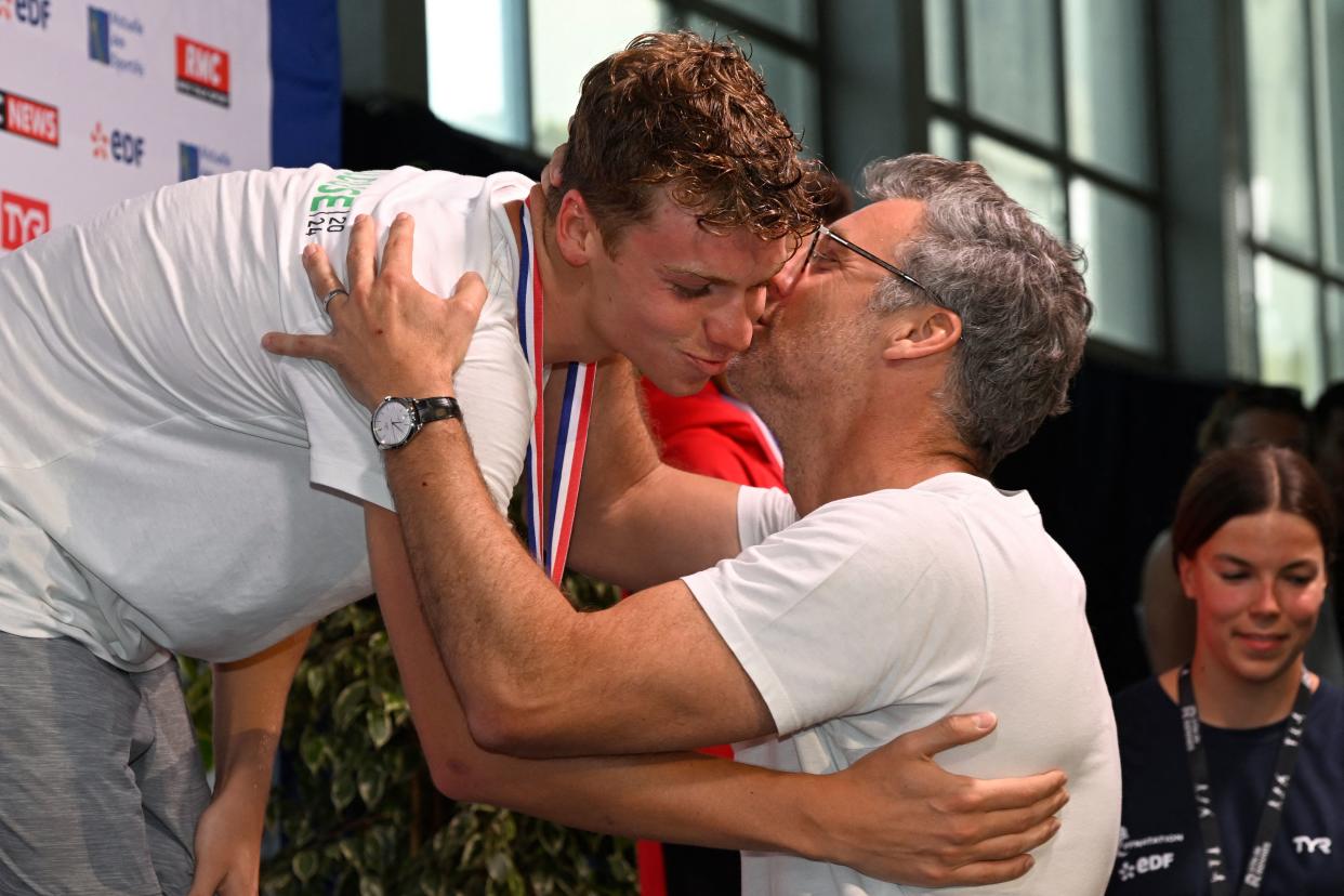 Léon Marchand, left, will follow his father, Xavier Marchand (right), to the Olympic Games. (Photo by DAMIEN MEYER/AFP via Getty Images)