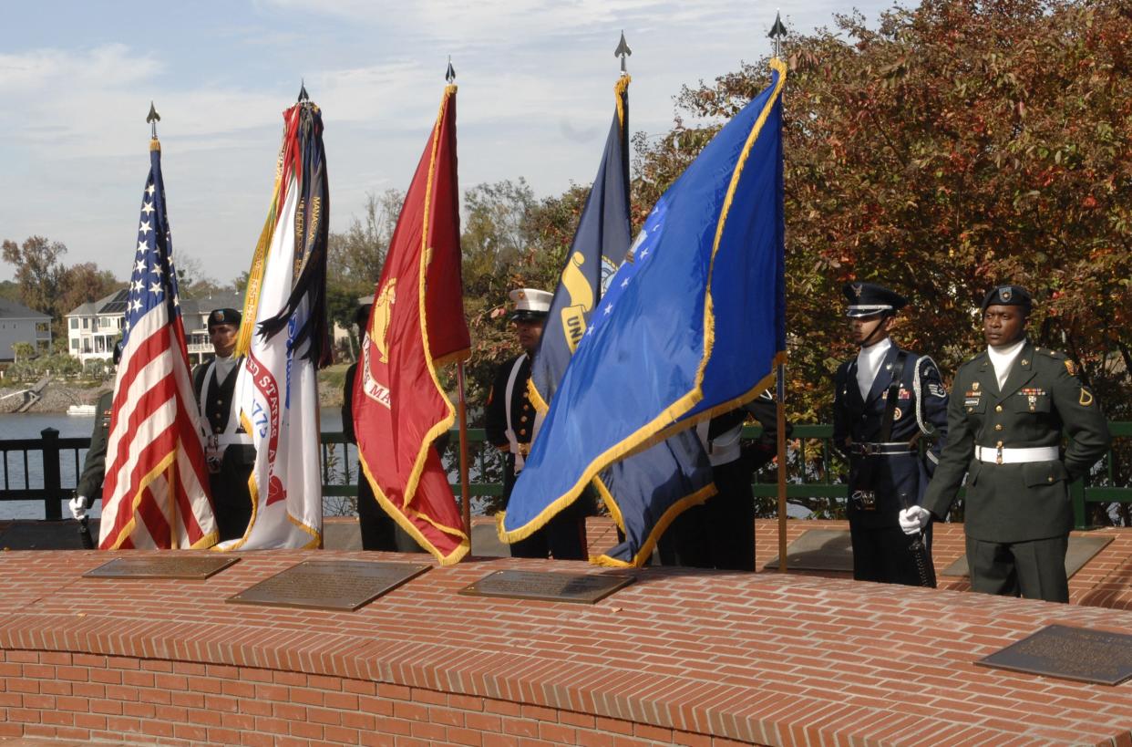 The Fort Gordon joint color guard stands behind the new wall at Heroes' Overlook as a dedication ceremony for the wall and three new plaques is held on Veterans Day, Nov. 11, 2008, in Augusta, Ga.
