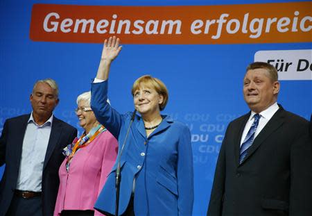 German Chancellor and leader of Christian Democratic Union (CDU) Angela Merkel waves as she arrives to address supporters after first exit polls in the German general election (Bundestagswahl) at the CDU party headquarters in Berlin September 22, 2013. REUTERS/Kai Pfaffenbach