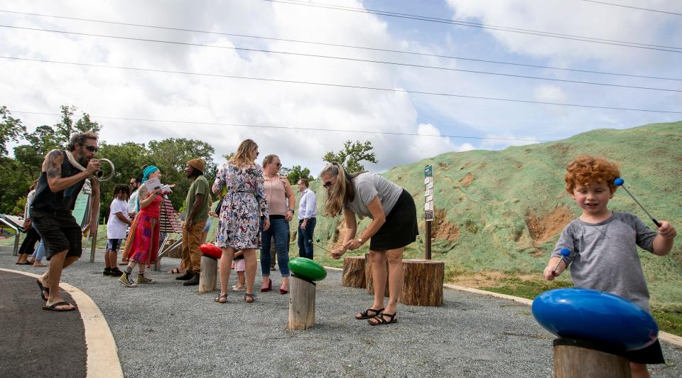 People play at the new Red Hills Rhythm musical parklet within Coal Chute Pond Park after its official opening ceremony Wednesday, July 13, 2022 in Tallahasse, Fla. 