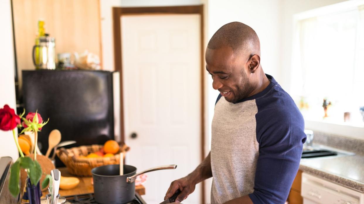 man standing happiness on the kitchen and preparing food