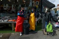 Fishmongers John Arkle and Paul Greenslade work at a fish stall