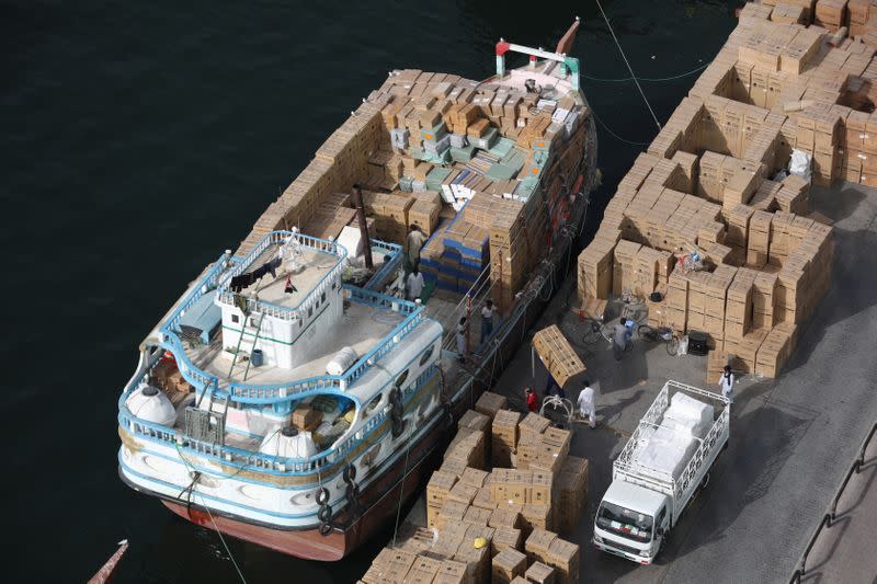 Workers load goods onto a dhow bound for Iran along the creek in old Dubai