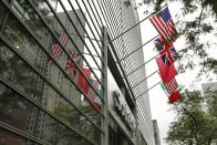 Flags fly on the front of Sotheby's auction house, in New York, Monday, June 17, 2019. BidFair USA is taking auction house Sotheby's private in a deal valued at $3.7 billion. (AP Photo/Richard Drew)